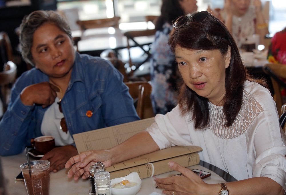 A former student Lee Pooi Mun (right) said the tree cannot be cut down without approval from the Ipoh city council.