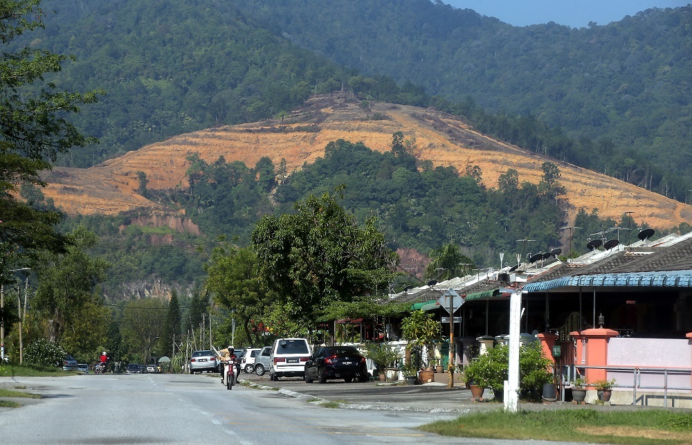 The land clearing of  Kledang Hill is clearly visible from some parts of the housing area located nearby. — Picture by Farhan Najib