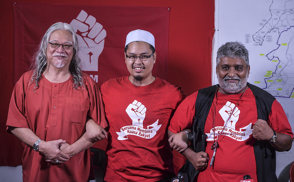 PSM president, Nasir Hashim, PSM candidate for Semenyih, Nik Aziz Afiq, and PSM party election director, S. Arutchelvan, smile during a press conference in Semenyih February 13, 2019. u00e2u20acu201d Picture by Shafwan Zaidon