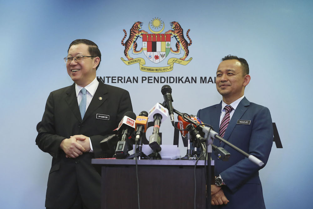 Finance Minister Lim Guan Eng and Education Minister Maszlee Malik react during a press conference at the Education Ministry in Putrajaya February 14, 2019. u00e2u20acu201d Picture by Yusof Mat Isa