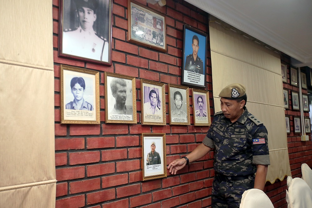 VAT 69’s deputy commander assistant commissioner Abd Rani Alias points out pictures of slain commandos at the Ulu Kinta General Operations Force base February 25, 2019. — Picture by Farhan Najib