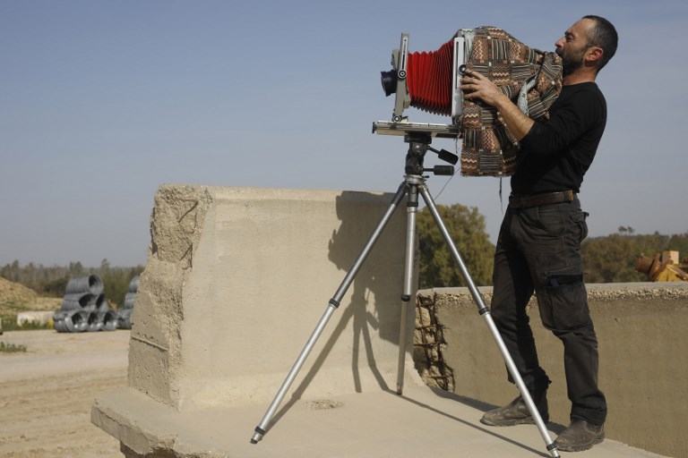 Edward Kaprov, an Israeli photographer,adjusts his large format camera, near Kibbutz Kissufim overlooking the northern Gaza border, on February 5 2019. u00e2u20acu201d AFP pic