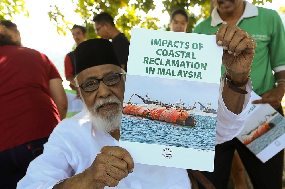 Sahabat Alam Malaysia chairman SM Idris showing the u00e2u20acu02dcImpacts Of Coastal Reclamation in Malaysiau00e2u20acu2122 booklet during a press conference at Queensbay in George Town February 27, 2019. u00e2u20acu201d Picture by Sayuti Zainudin
