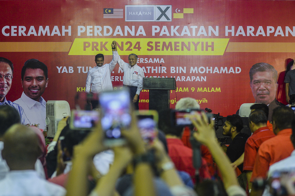 Tun Dr Mahathir Mohamad and Pakatan Harapan candidate for Semenyih Muhammad Aiman Zainali (left) on stage during the Ceramah Perdana Pakatan Harapan in Semenyih February 28, 2019. u00e2u20acu201d Picture by Hari Anggara