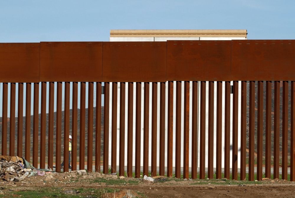 A worker walks near a prototype for US President Donald Trump's border wall, as seen through the border fence between Mexico and the United States, in Tijuana, Mexico January 7, 2019. u00e2u20acu201d Reuters pic
