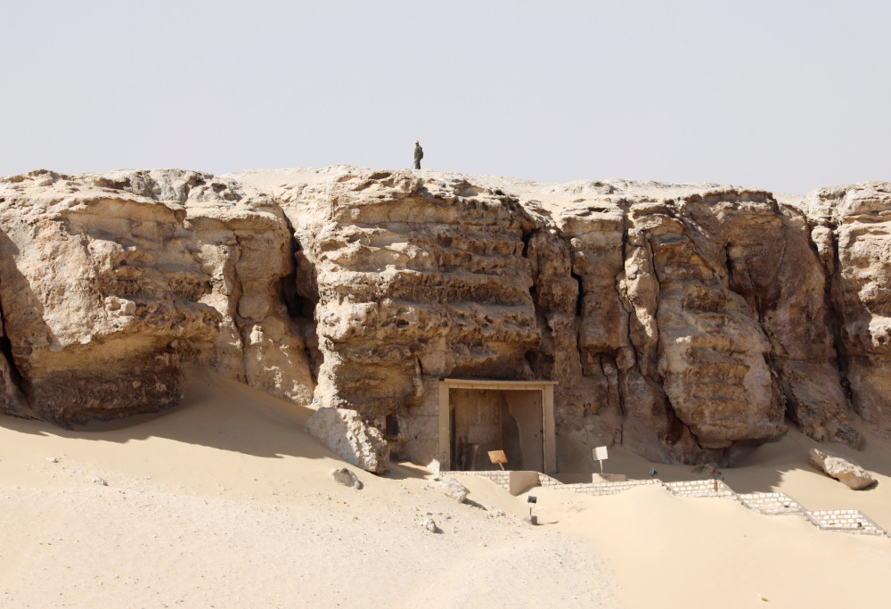A member of security personnel stands atop of a cliff as he guards the area during the presentation of a new discovery at Tuna el-Gebel archaeological site in Minya Governorate, Egypt, February 2, 2019. u00e2u20acu201d Reuters pic 