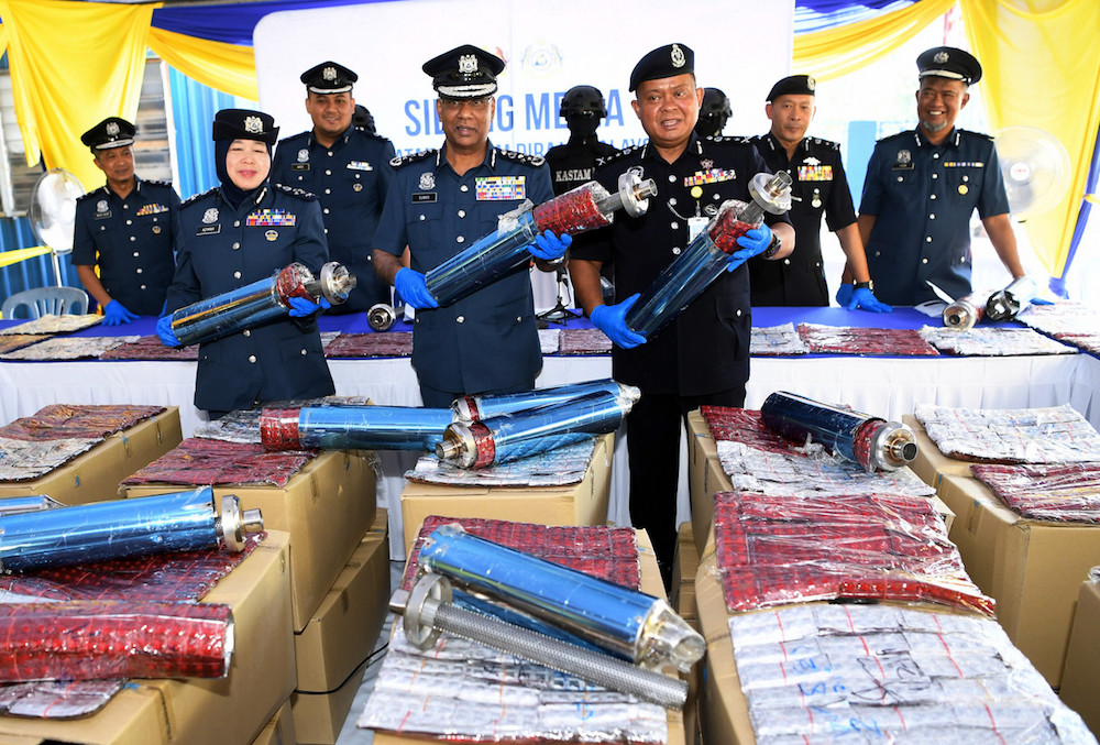 Customs director-general Datuk Seri T. Subromaniam shows the motorcycle exhaust pipes that were used to conceal the Eramin 5 pills during a press conference in Nilai February 8, 2019. u00e2u20acu201d Bernama pic