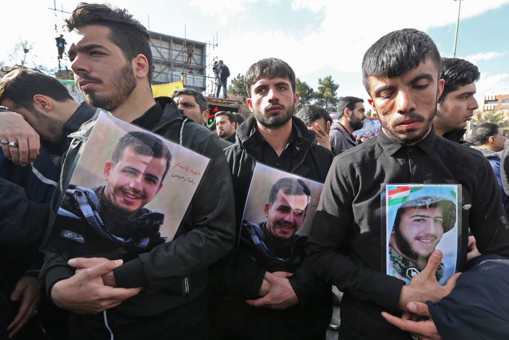 Iranian men hold portraits of their relatives, members of Revolutionary Guards who were killed in a suicide attack, in the central Iranian city of Isfahan on February 16, 2019. u00e2u20acu201d AFP pic 
