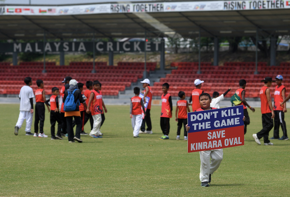 A boy holds a sign during a protest against the closure of the Kinrara Oval in Kuala Lumpur October 6, 2018. u00e2u20acu201d Bernama pic