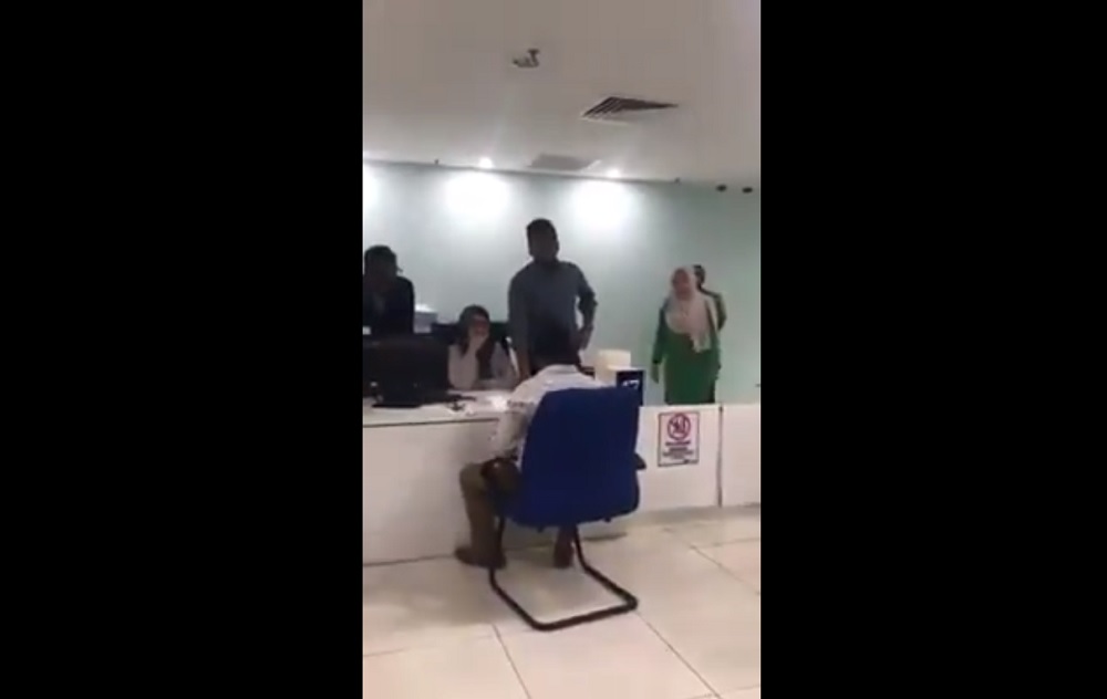 Screenshot of a video of a man scolding staff manning the counter at APADu00e2u20acu2122s Kelana Jaya office. u00e2u20acu201d Picture via Twitter/Hilmi Adi Ruzaini