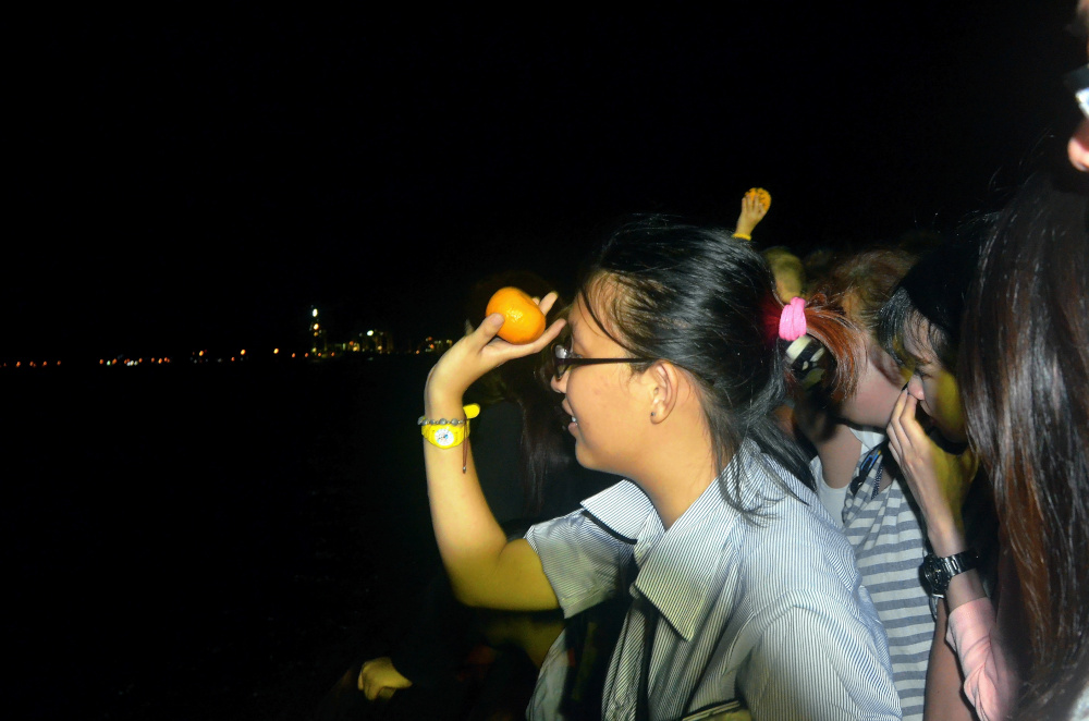 Chap Goh Meh is an ancient ritual whereby young unmarried ladies toss oranges inscribed with names and telephone numbers into lakes or rivers in search of a boyfriend or husband. — Picture by R. Mahgeshan    
