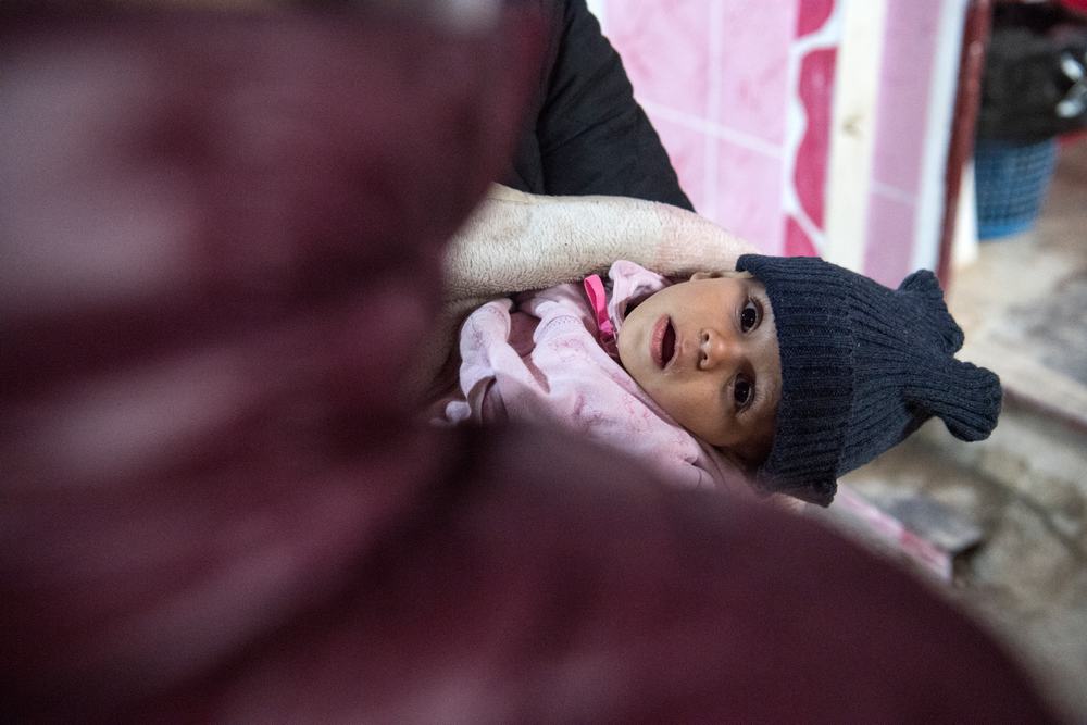 A woman carrying a child waits at a makeshift clinic at the Internally Displaced Persons (IDP) camp of al-Hol in al-Hasakeh governorate in northeastern Syria on February 7, 2019. u00e2u20acu201d AFP pic