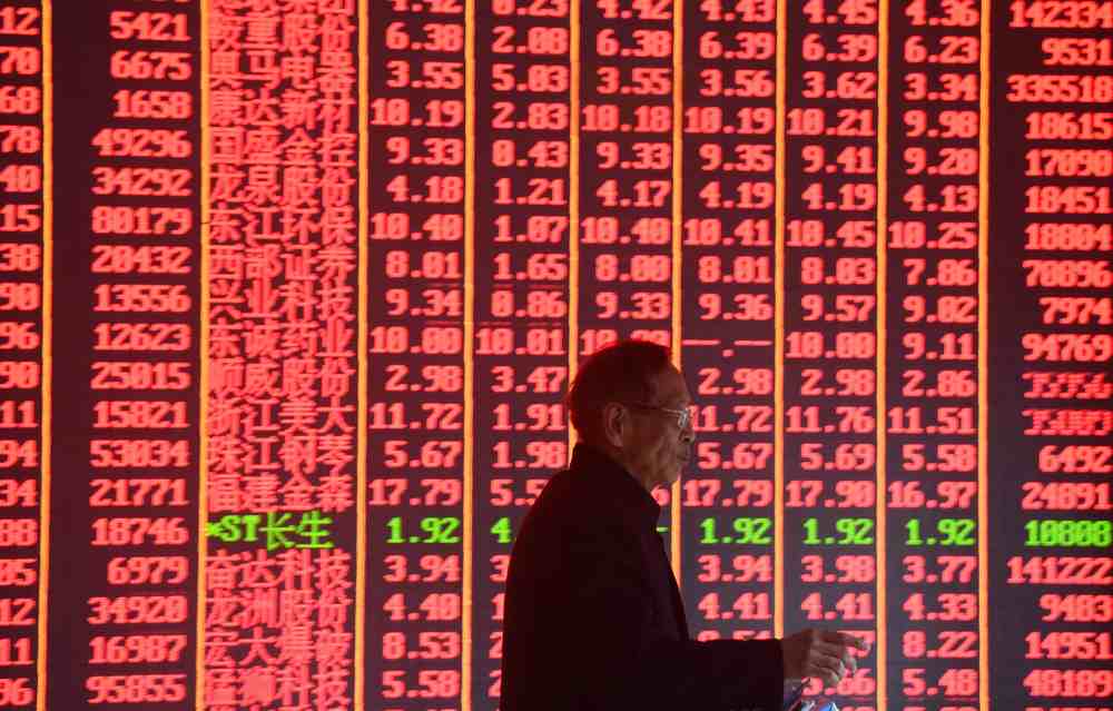 A man is seen in front of an electronic board showing stock information on the first day of trading in the Year of the Pig at a brokerage house in Hangzhou, Zhejiang province, China February 11, 2019. u00e2u20acu201d Reuters pic