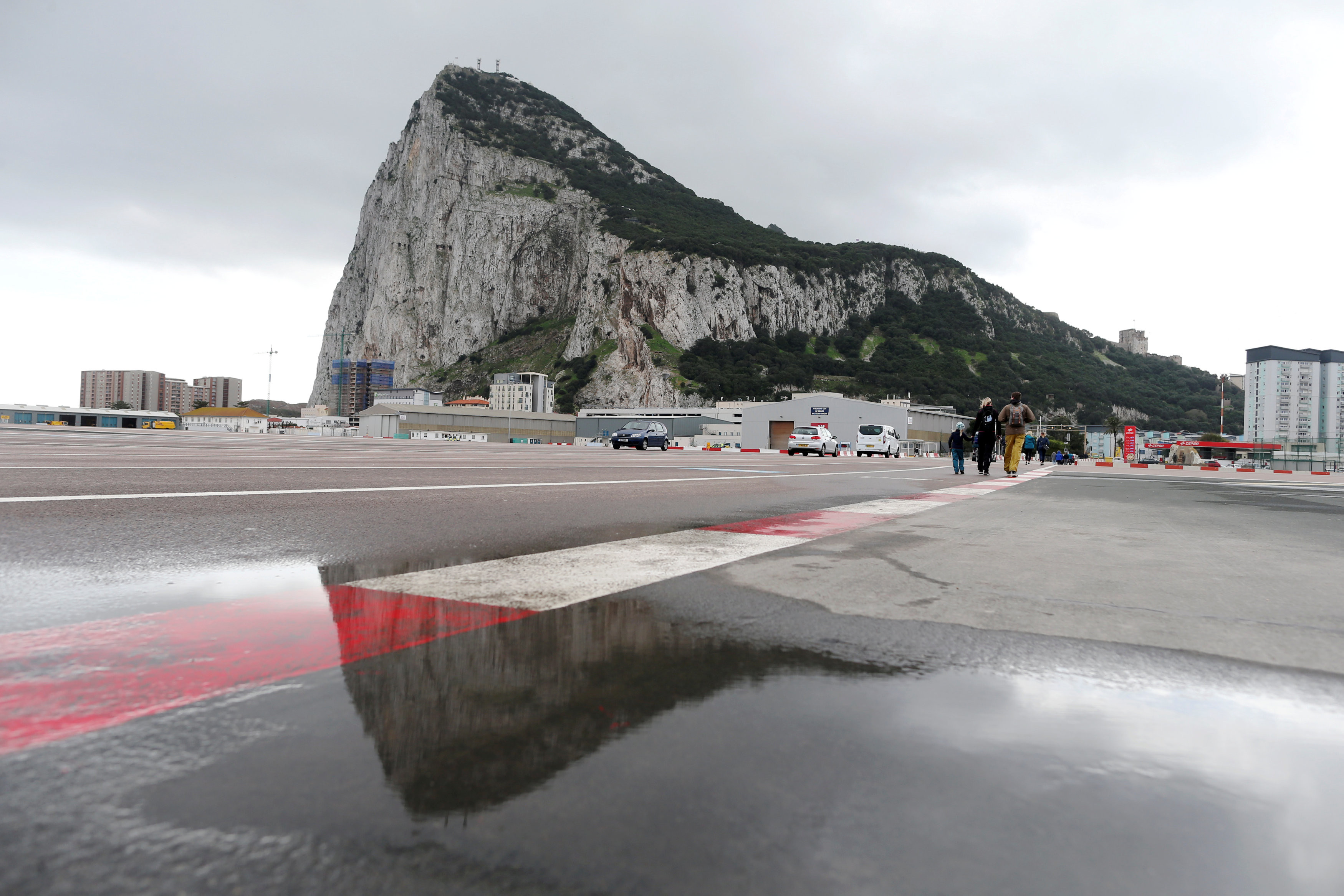 Pedestrians cross the tarmac at Gibraltar International Airport, in front of the Rock, near the border with Spain in the British overseas territory of Gibraltar, historically claimed by Spain, November 25, 2018. u00e2u20acu201d Reuters pic 