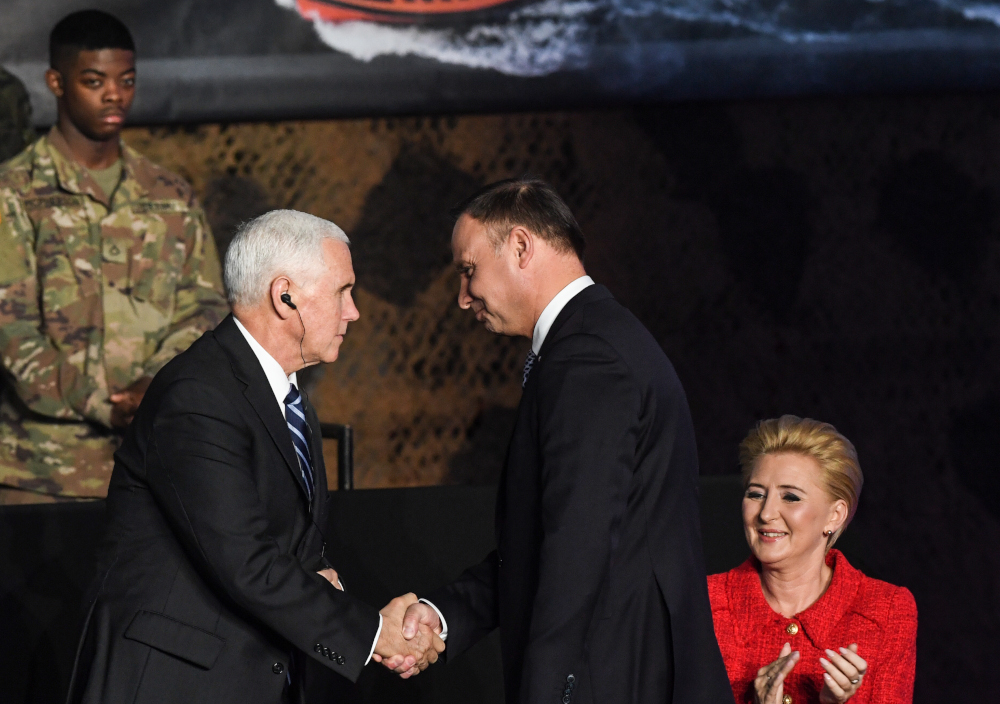 US Vice-President Mike Pence (left) shakes hands with Polandu00e2u20acu2122s President Andrzej Duda next to Agata Kornhauser-Duda during a visit at the 1st Airlift Base in Warsaw, on February 13, 2019 during a three-day visit to Poland. u00e2u20acu201d AFP pic 