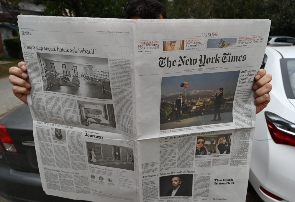 A Pakistani journalist reads a local edition of the u00e2u20acu02dcInternational New York Timesu00e2u20acu2122 in Islamabad on February 12, 2019, which shows a single-column blank space on the front page. u00e2u20acu201d AFP pic