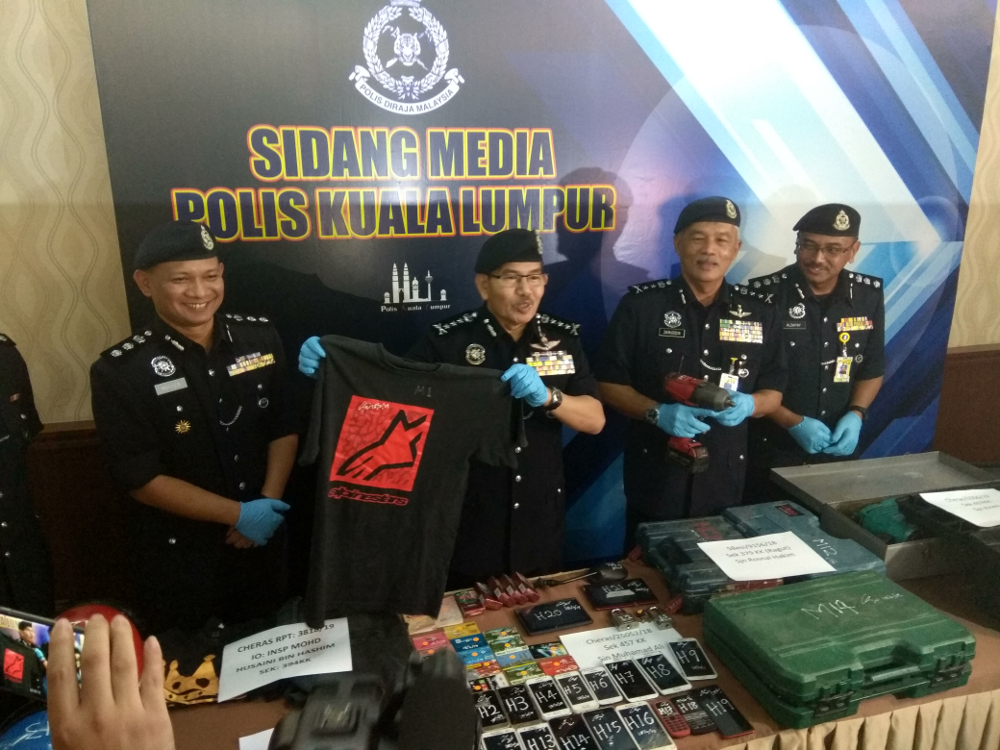 Kuala Lumpur police chief Datuk Seri Mazlan Lazim holding up the shirt wore by the suspect during the incident that was confiscated during a raid February 19, 2019. u00e2u20acu201d Picture by Kenneth Tee