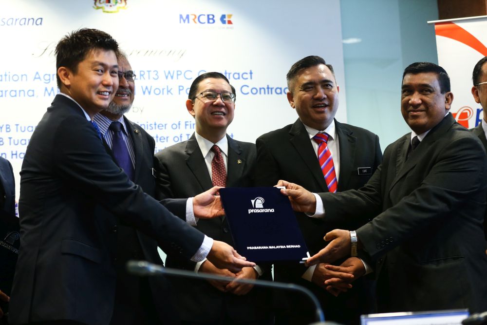 Lim Guan Eng (centre), Anthony Loke (second from right) and Khalid Samad (second from left) witness the signing ceremony of the renovation agreement of the LRT3 project at UOA Tower, Bangsar February 22, 2019. u00e2u20acu2022 Picture by Ahmad Zamzahuri