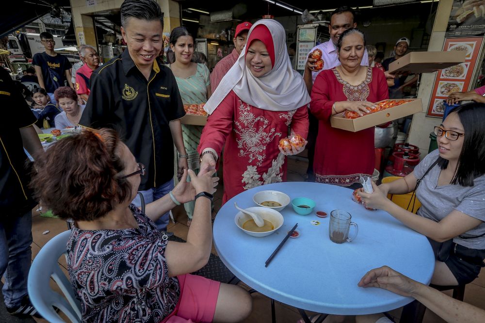 Rural and Regional Development Minister Datuk Seri Rina Harun distributes mandarin oranges to members of the public at Taman Maluri, Cheras February 3, 2019. u00e2u20acu201d Picture by Firdaus Latif