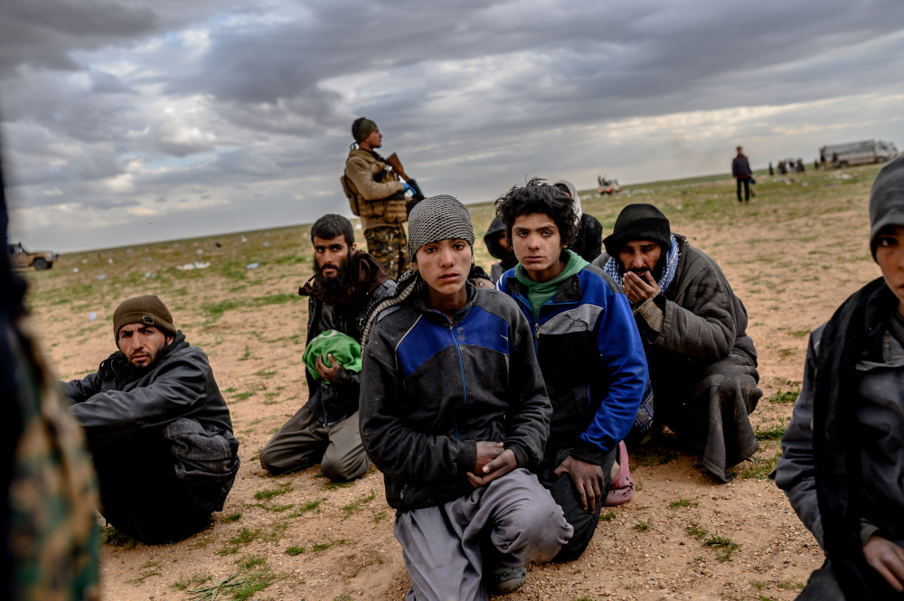 Men and boys suspected of being Islamic State fighters wait to be searched by members of the Syrian Democratic Forces (SDF) after leaving the IS groupu00e2u20acu2122s last holdout of Baghouz, in Deir Ezzor, Syria on February 27, 2019. u00e2u20acu201d AFP pic 