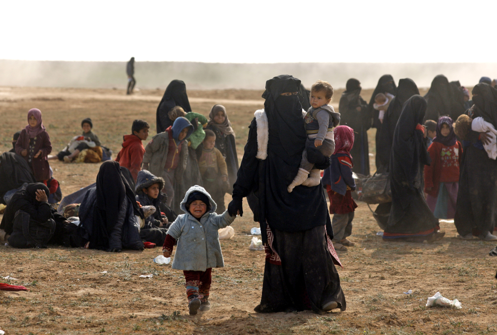 Civilians fleeing the Islamic Stateu00e2u20acu2122s group embattled holdout of Baghouz gather in a field on February 13, 2019 during an operation by the US-backed Syrian Democratic Forces. u00e2u20acu201d AFP pic 