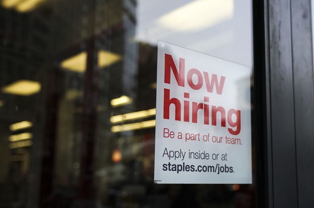 A u00e2u20acu02dcnow hiringu00e2u20acu2122 sign hangs on the door of a Staples store in Lower Manhattan in New York City, January 4, 2019. u00e2u20acu201d AFP pic