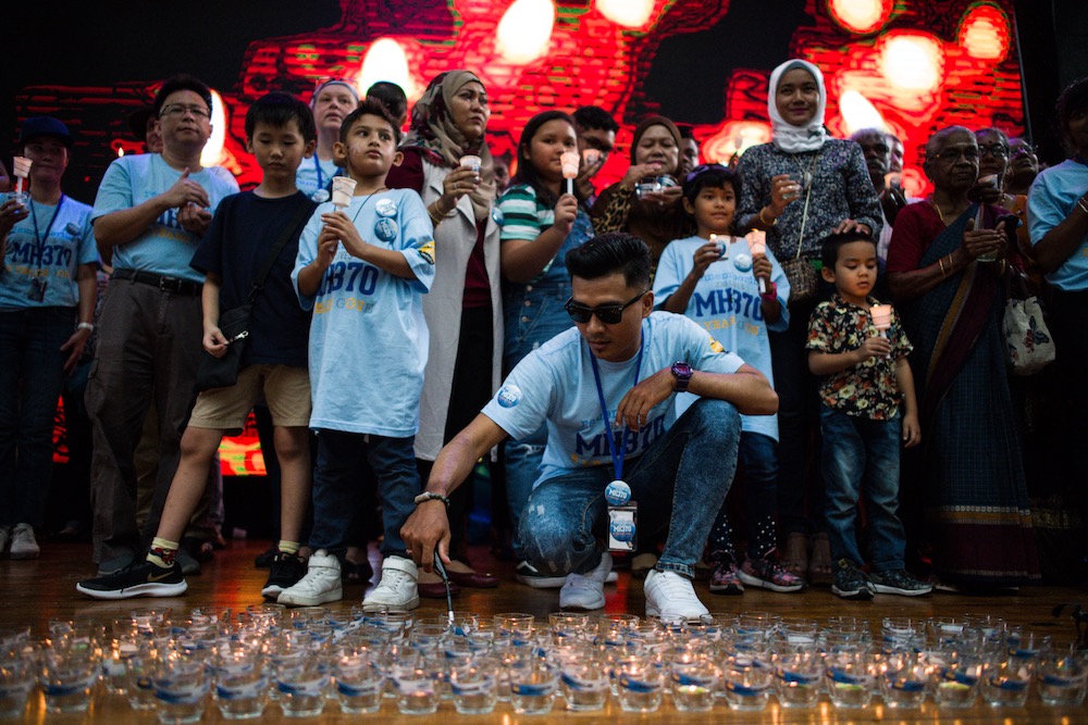 Family members with unaccounted for loved ones hold lit candles during a memorial event ahead of the fifth anniversary of the missing Malaysia Airlines flight MH370 in Kuala Lumpur March 3, 2019. u00e2u20acu201d AFP pic