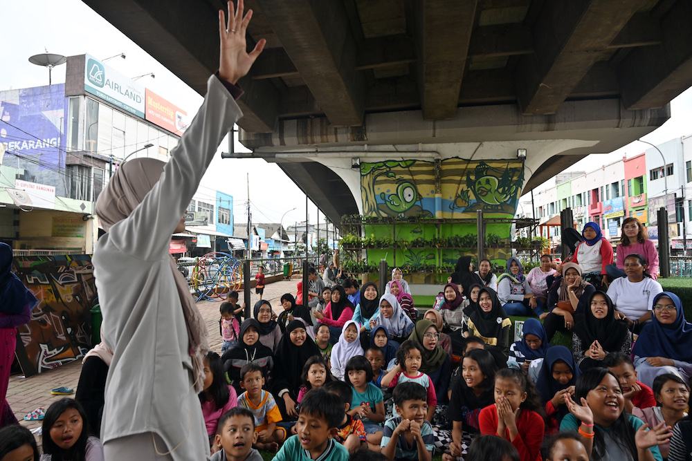 Children attend a programme at the under bridge library called u00e2u20acu02dcTBM Kolongu00e2u20acu2122 in Tangerang, Banten province February 10, 2019. u00e2u20acu201d AFP pic