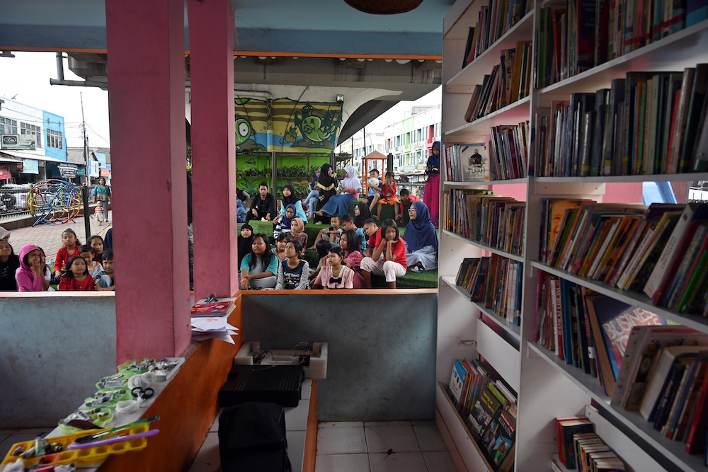Children attend a programme at the under bridge library called ‘TBM Kolong’ in Tangerang, Banten province February 10, 2019. — AFP pic