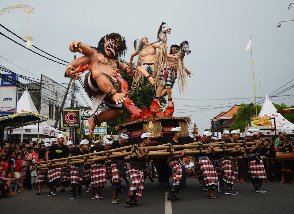 Balinese people carry an Ogoh-Ogoh effigy during a parade ahead of the u00e2u20acu02dcDay of Silence,u00e2u20acu2122 locally known as Nyepi, in Denpasar on Indonesiau00e2u20acu2122s resort island of Bali. u00e2u20acu201d AFP pic