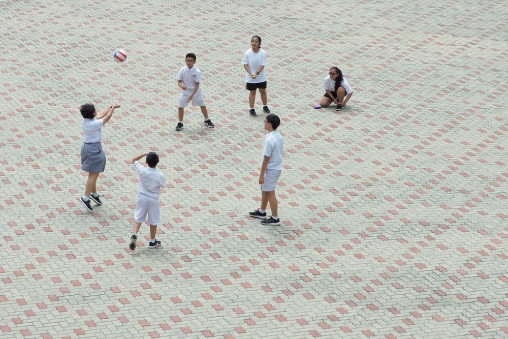 Students playing an informal game of volleyball at Edgefield Secondary School in Singapore. After about four decades since it was introduced, the Education Ministry will scrap streaming in 2024 and replace it with subject-based banding. u00e2u20acu201d TODAY pic