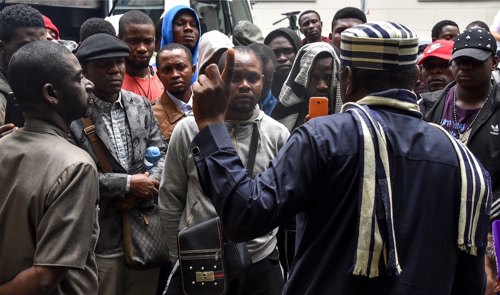 Ambassador of Nigeria to Russia Steve Davies Ugbah (back) speaks with Nigerians in front of Nigerian embassy in Moscow July 13, 2918. u00e2u20acu201d AFP pic
