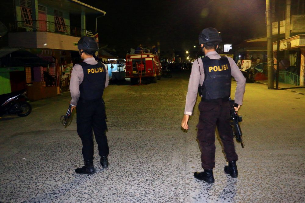 Armed police officers stand as they guard an area following an explosion after they arrested a suspected terrorist in Sibolga, North Sumatra province, Indonesia, March 12, 2019. u00e2u20acu201d Antara Foto/Jason Gultom pic via Reuters