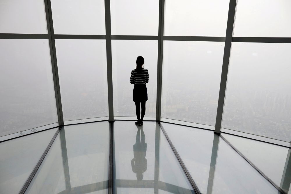 A woman looks at a view of Seoul shrouded by fine dust during a polluted day in Seoul, South Korea, March 6, 2019. u00e2u20acu201d Reuters file pic