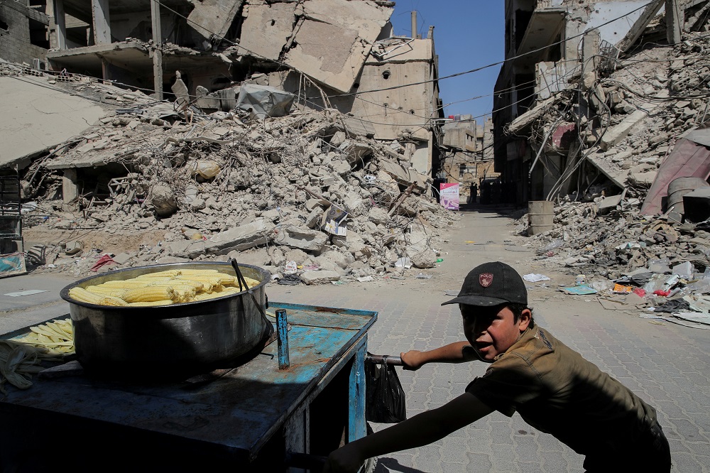 A child pushes a cart selling cooked sweetcorn in Douma, outside Damascus, Syria September 17, 2018. u00e2u20acu201d Reuters pic
