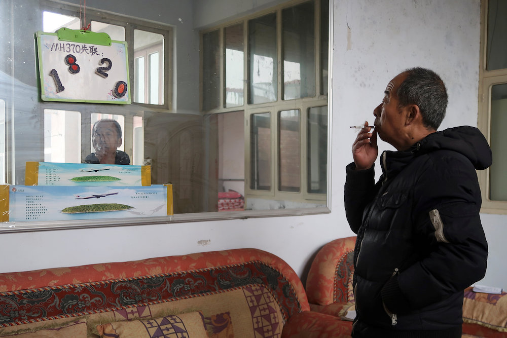 Li Eryou poses in front of a sign marking the number of days his son went missing, during a Reuters interview at his house in Handan, Hebei province, China March 1, 2019. — Reuters pic