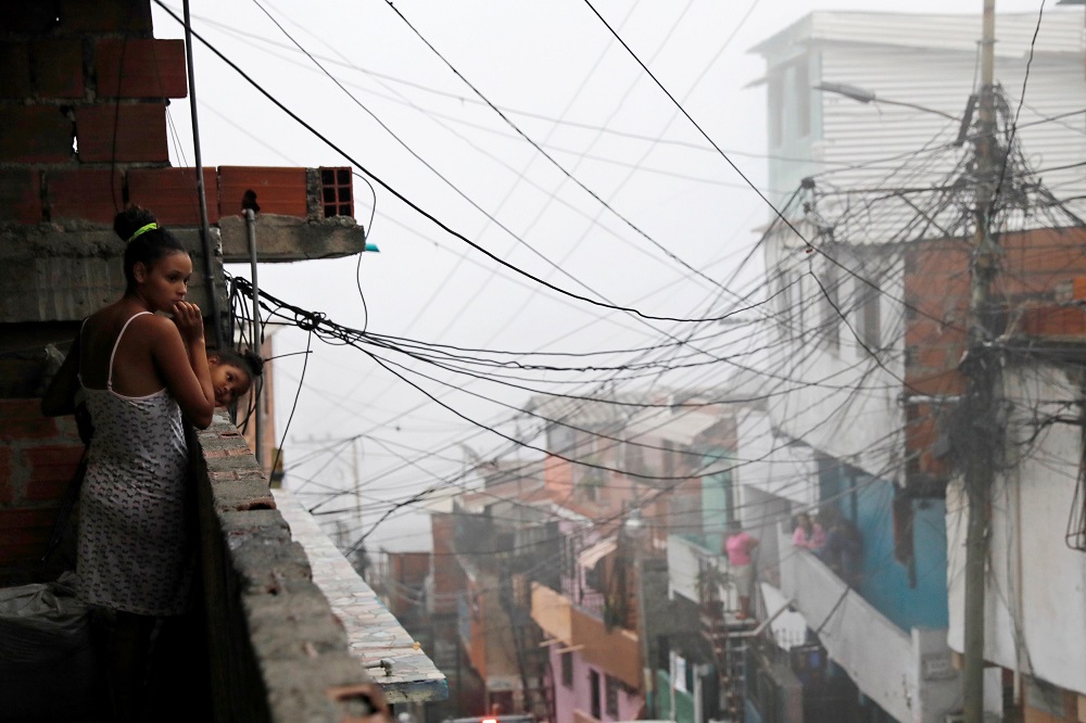 A woman looks from a balcony during a blackout in Catia slum in Caracas March 8, 2019. u00e2u20acu201d Reuters pic