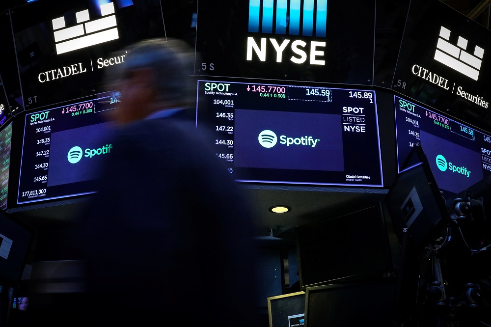 A trader passes by screens showing Spotify on the floor at the New York Stock Exchange March 13, 2019. u00e2u20acu201d Reuters pic