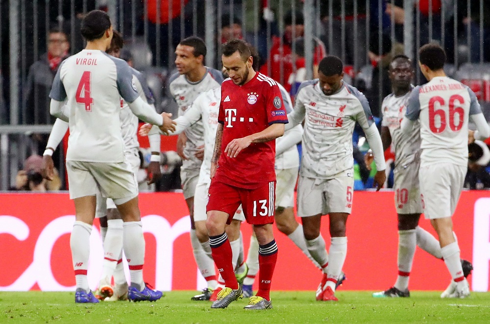 Bayern Munichu00e2u20acu2122s Rafinha looks dejected as Liverpoolu00e2u20acu2122s Sadio Mane celebrates scoring their third goal with team mates at the Allianz Arena in Munich March 13, 2019. u00e2u20acu201d Reuters pic