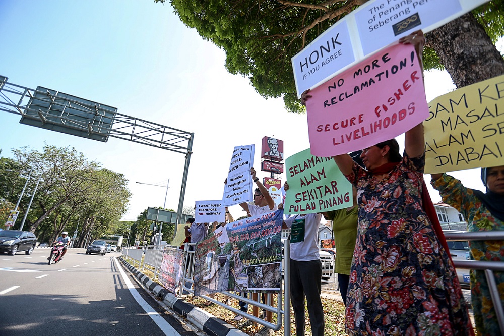 People line the street in protest against the Penang South Reclamation project at Jalan Masjid Negeri in George Town March 1, 2019.