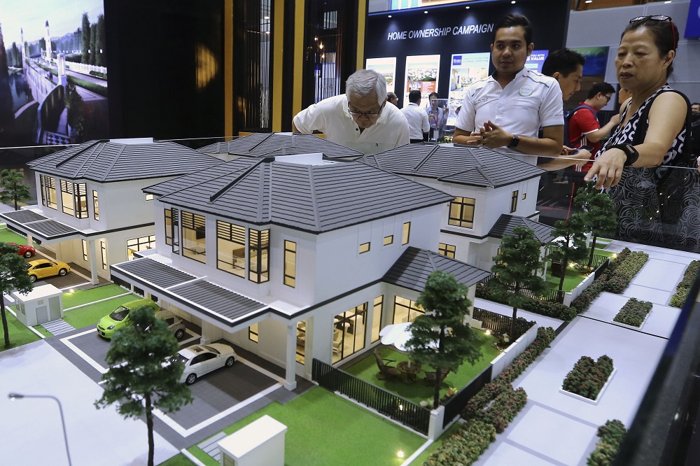 People looking at models of homes for sale during the launch of the Home Ownership Campaign at the Kuala Lumpur Convention Centre March 1, 2019. u00e2u20acu201d Picture by Yusof Mat Isa