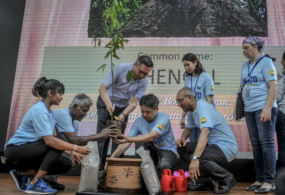 Transport Minister Anthony Loke plants a tree with family members of passengers of the missing MH370 during the remembrance ceremony to mark the 5th anniversary of the plane’s disappearance in Kuala Lumpur March 3, 2019. — Picture by FIrdaus Latif 