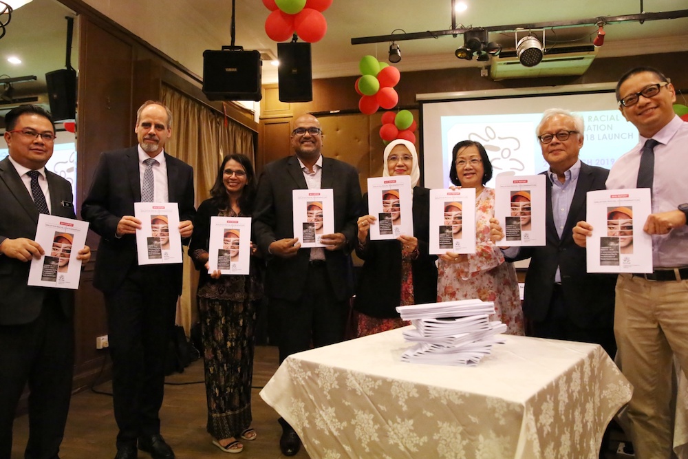 Panellists hold copies of Pusat Komasu00e2u20acu2122 2018 Malaysia Racial Discrimination report during its launch in Kuala Lumpur March 21, 2019. u00e2u20acu201d Picture by Choo Choy May