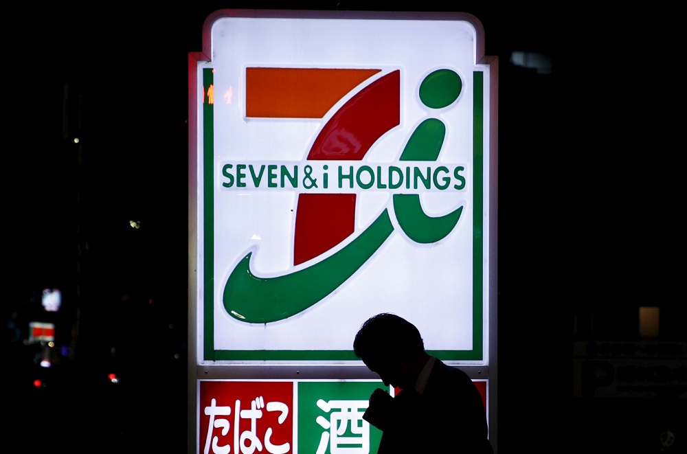A pedestrian walks in front of a signage of Seven & I Holdings' 7-Eleven convenience store in Tokyo April 7, 2016. u00e2u20acu201d Reuters pic