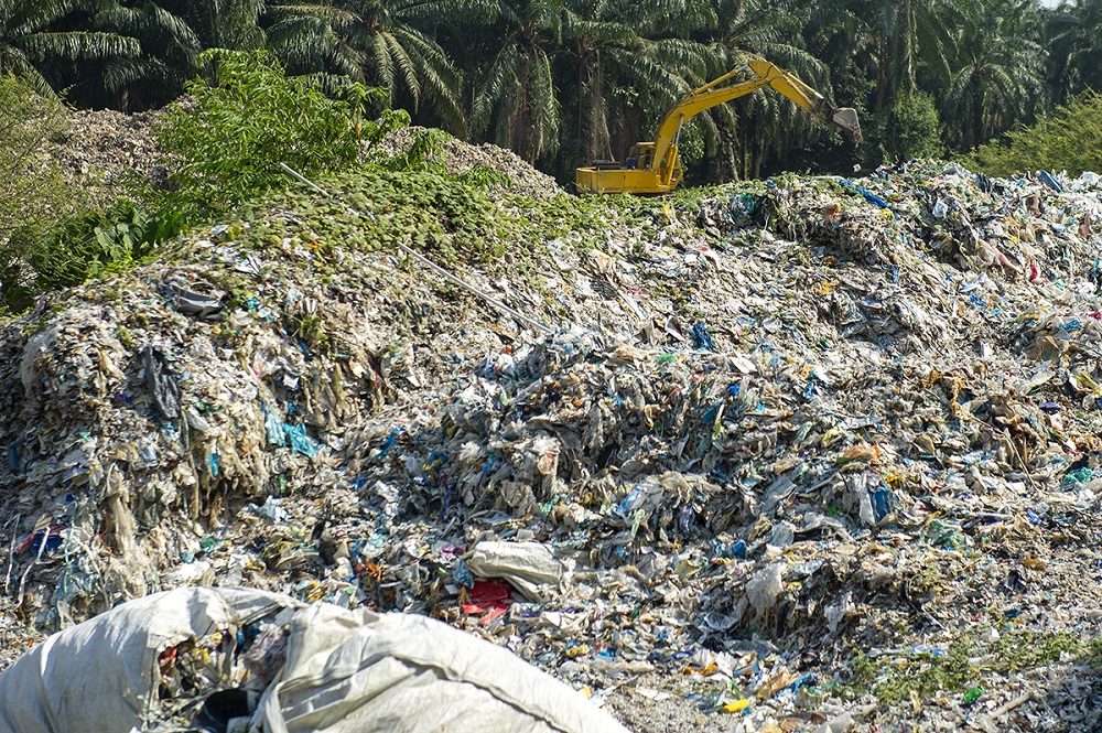 An excavator is seen clearing piles of plastic at an illegal recycling site in Jenjarom, Banting March 26, 2019. u00e2u20acu201d Picture by Mukhriz Hazim