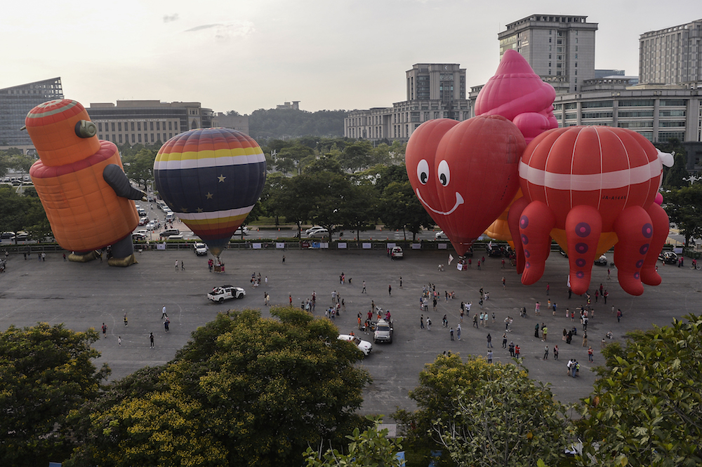 Hot air balloons take flight during the International Hot Air Balloon Fiesta in Putrajaya March 28, 2018. — Picture by Miera Zulyana