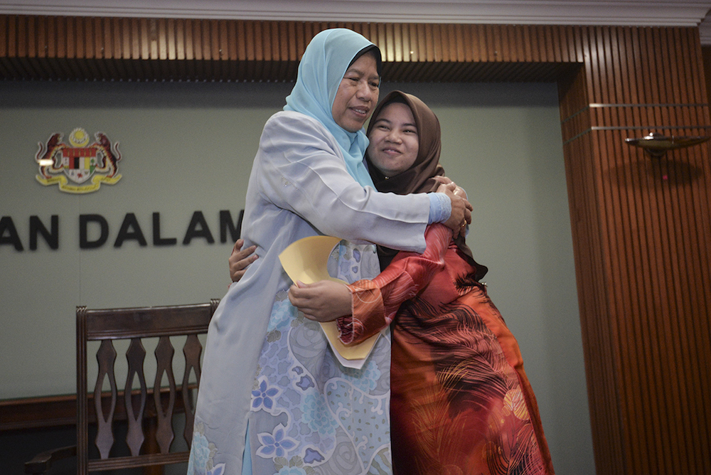 Housing and Local Government Minister Zuraida Kamaruddin hugs her ward Roisah Abdullah after the latter received her national citizenship letter in Putrajaya March 28, 2019. u00e2u20acu201d Picture by Shafwan Zaidon