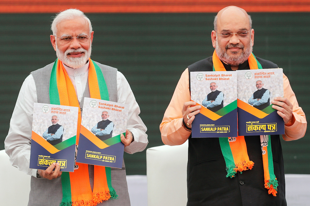 Indian Prime Minister Narendra Modi and chief of India's ruling Bharatiya Janata Party (BJP) Amit Shah, display copies of their party's election manifesto for the April/May general election in New Delhi April 8, 2019. u00e2u20acu201d Reuters picnn