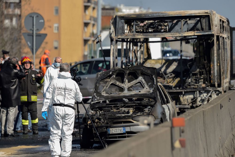 Forensic policemen and firefighters work by the wreckage of a school bus that was transporting some 50 children is pictured March 20, 2019, in San Donato Milanese, southeast of Milan. u00e2u20acu201d Flavio Lo Scalzo pic via AFPn