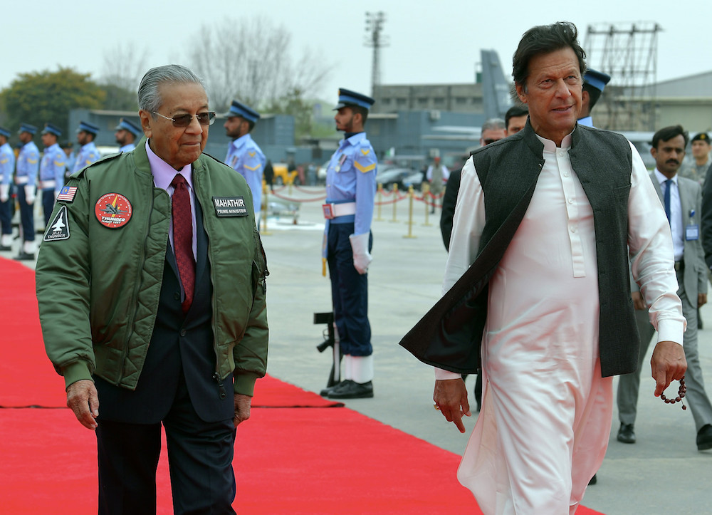 Prime Minister Tun Dr Mahathir Mohamad is accompanied by his counterpart Imran Khan as he departs Pakistan from Pakistan Air Force Base Nur Khan Rawalpindi in Islamabad March 23, 2019. u00e2u20acu201d Bernama pic